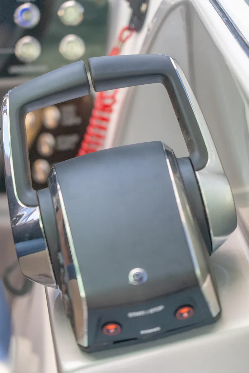 Slide: The Image of Close-up of 2025 Hanover 305 Outboard throttle control in a boat cockpit. - 16