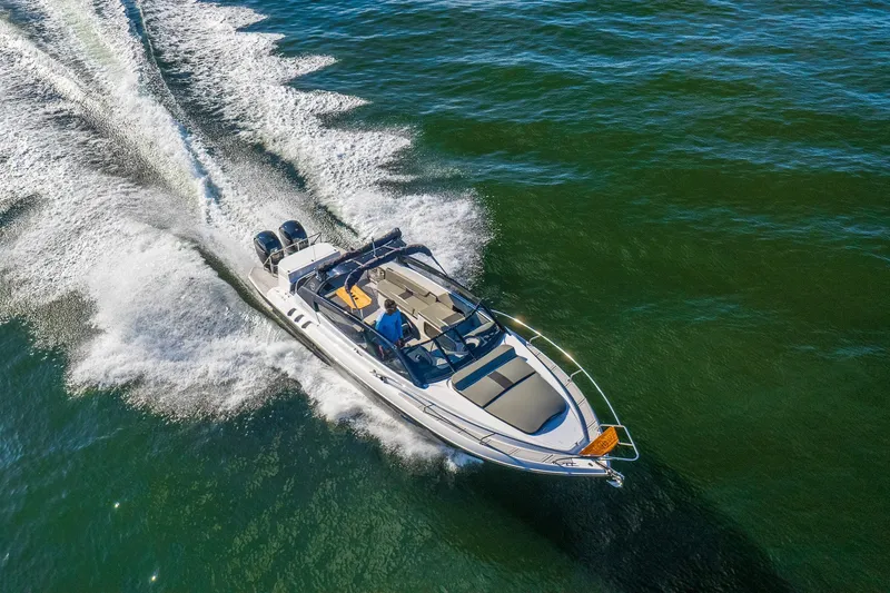 Slide: The Image of 2025 Hanover 305 Outboard boat cruising on open water, aerial view. - 4