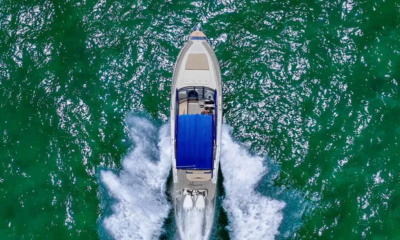 Slide: The Image of Aerial view of 2025 Hanover 305 Outboard boat cruising on vibrant green water. - 5