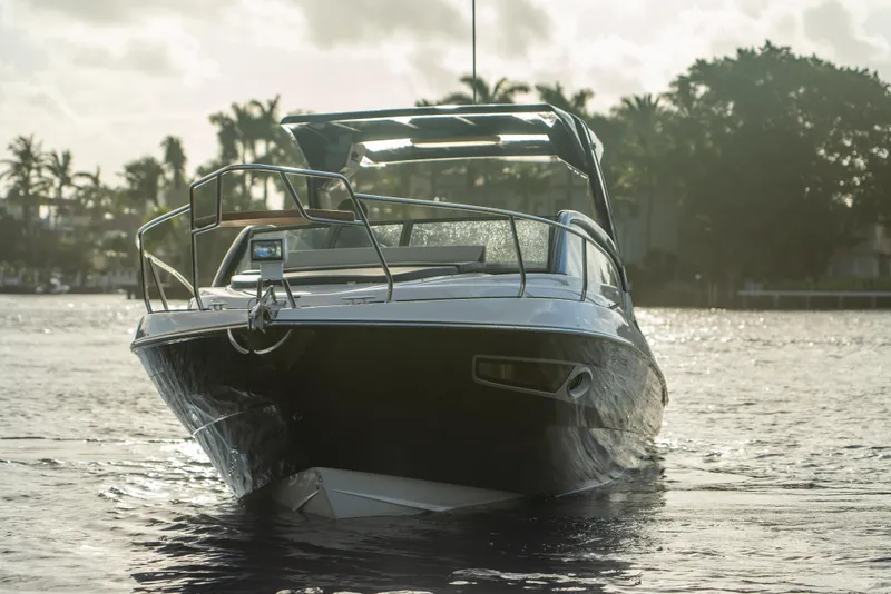 Slide: The Image of 2025 Hanover 305 Outboard boat on water, surrounded by trees and a cloudy sky. - 7