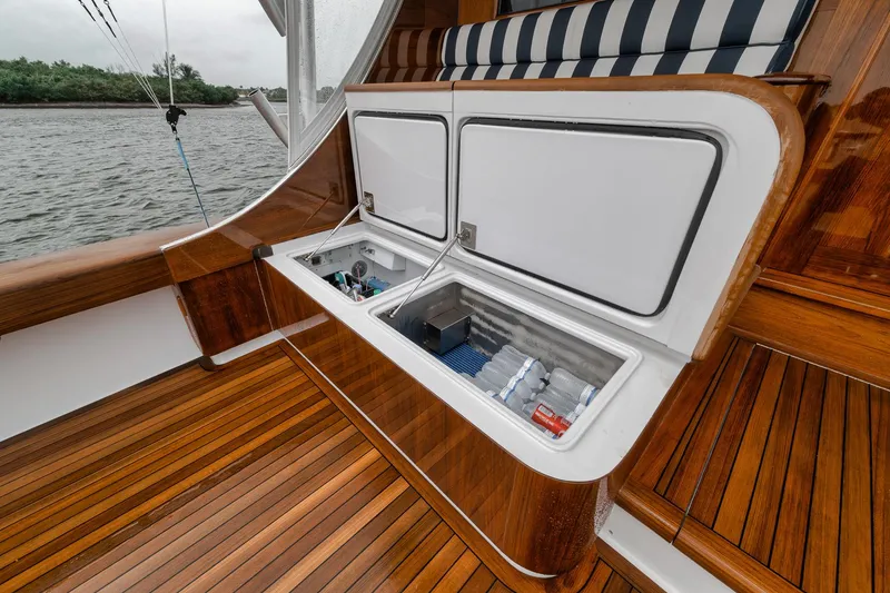 Slide: The Image of Open storage compartment on 2011 Jim Smith Custom Sportfish boat with wooden deck. - 13