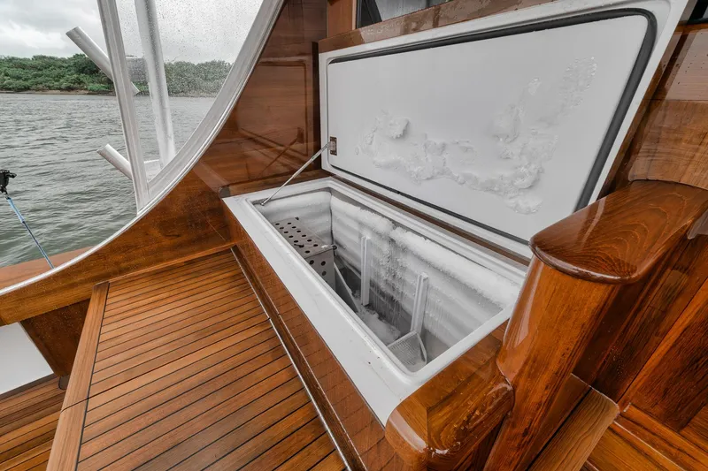 Slide: The Image of Open freezer on 2011 Jim Smith Custom Sportfish boat with wooden deck. - 15