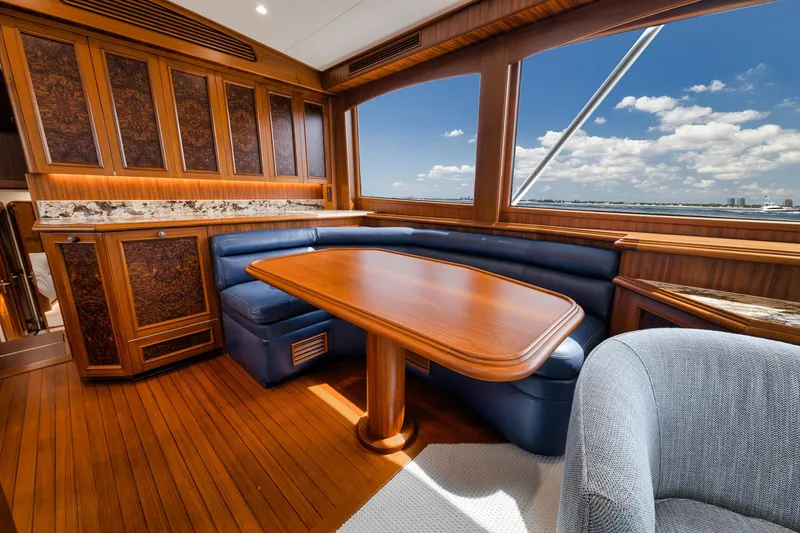 Slide: The Image of Luxurious interior of 2011 Jim Smith Custom Sportfish yacht with wooden table and blue seating. - 28