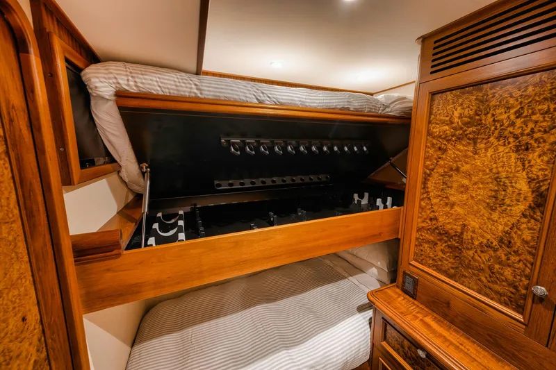 Slide: The Image of Luxurious cabin interior of 2011 Jim Smith Custom Sportfish with wood finishes and cozy bedding. - 39