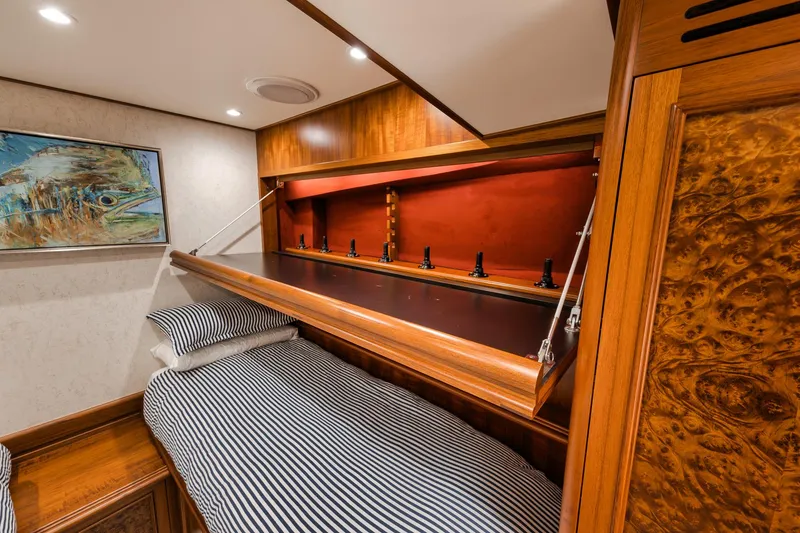 Slide: The Image of Luxurious cabin interior of 2011 Jim Smith Custom Sportfish with striped bedding and wood accents. - 43