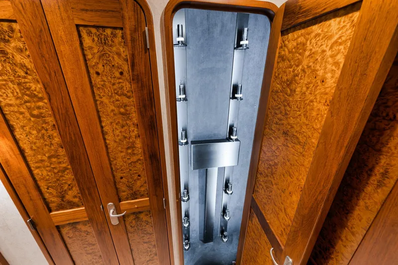 Slide: The Image of Wooden cabinet with fishing rod storage inside a 2011 Jim Smith Custom Sportfish boat. - 45
