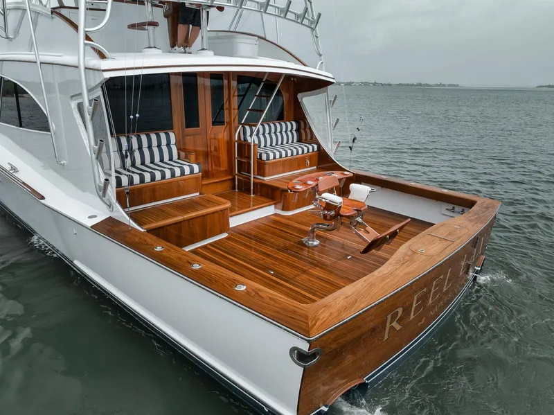 Slide: The Image of Luxurious 2011 Jim Smith Custom Sportfish yacht with elegant wood deck and striped seating. - 5