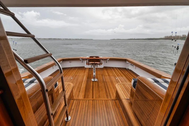Slide: The Image of Luxurious 2011 Jim Smith Custom Sportfish yacht deck with wooden finish overlooking the ocean. - 7