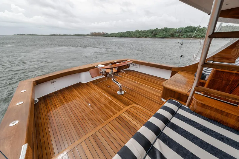 Slide: The Image of Luxurious 2011 Jim Smith Custom Sportfish yacht deck with wooden finish and scenic water view. - 8