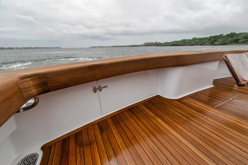 Slide: The Image of Luxurious 2011 Jim Smith Custom Sportfish boat with polished wooden deck and scenic ocean view. - 9