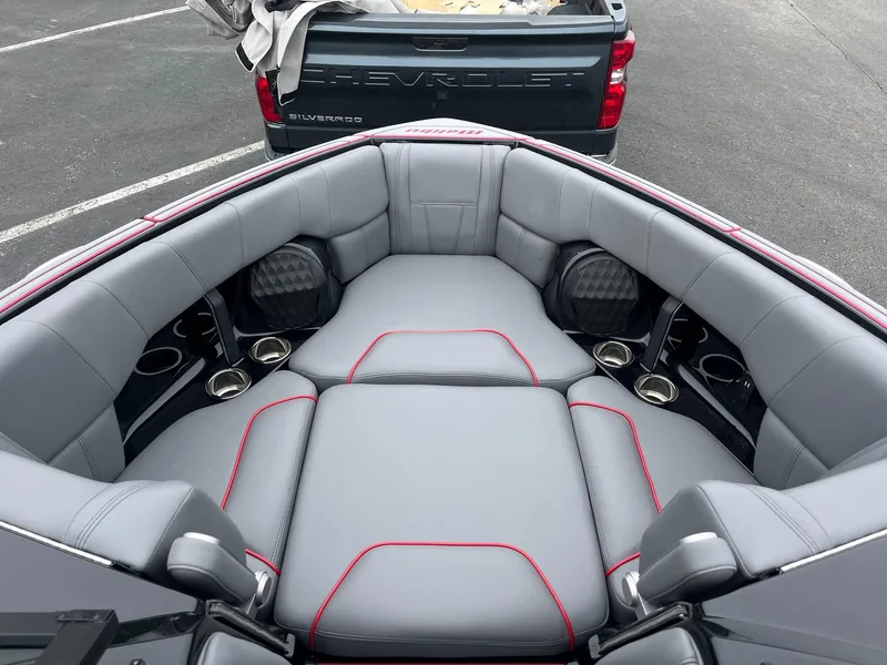 Slide: The Image of 2022 Malibu Wakesetter 23 LSV boat interior with gray seating and cup holders. - 12