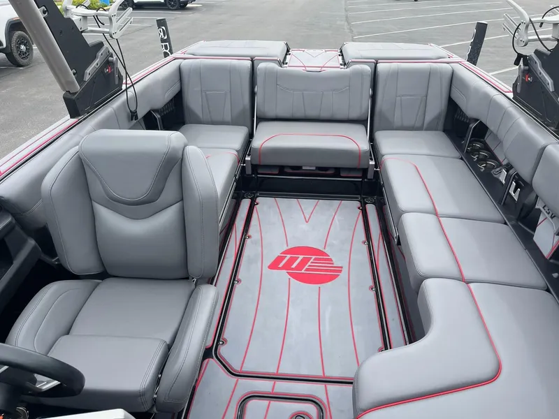 Slide: The Image of 2022 Malibu Wakesetter 23 LSV interior with gray seating and red accents. - 13