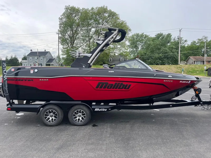 Slide: The Image of 2022 Malibu Wakesetter 23 LSV boat in red and black on a trailer. - 4