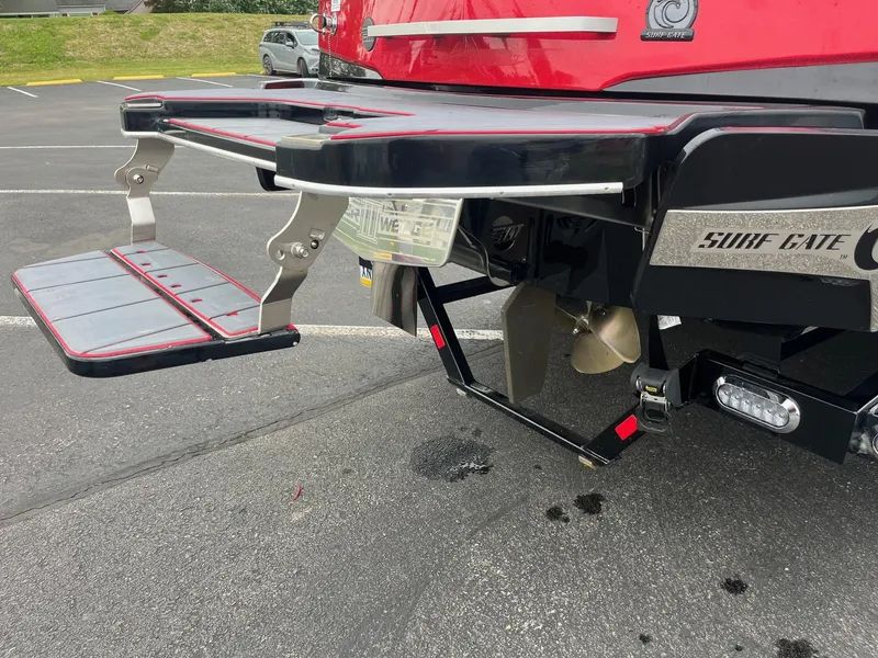 Slide: The Image of 2022 Malibu Wakesetter 23 LSV rear view with swim platform and surf gate. - 7