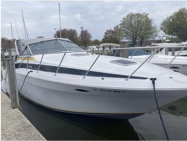 The Image of 1987 Chris-Craft 320 Amerosport boat docked at marina under cloudy sky. - 0