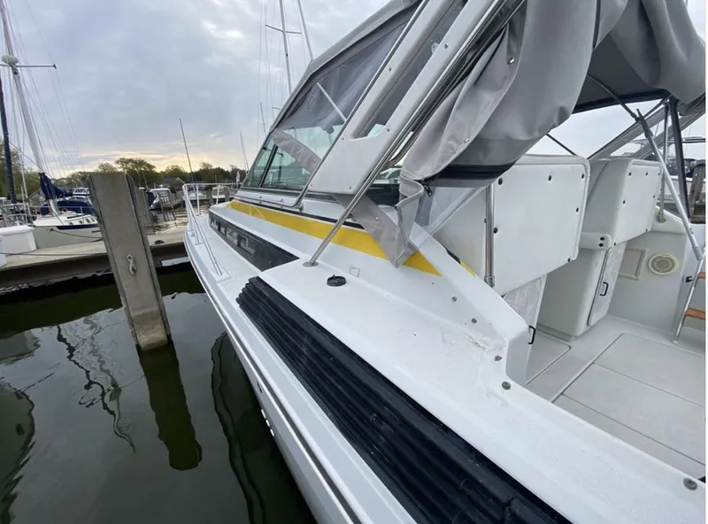 Slide: The Image of 1987 Chris-Craft 320 Amerosport boat docked at marina, featuring sleek design and spacious interior. - 1