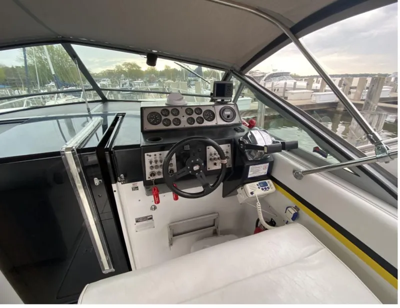 Slide: The Image of 1987 Chris-Craft 320 Amerosport boat cockpit with steering wheel and control panel. - 11