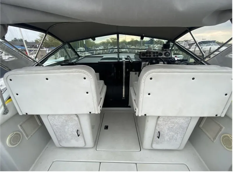 Slide: The Image of 1987 Chris-Craft 320 Amerosport boat cockpit with dual white seats and control panel. - 12