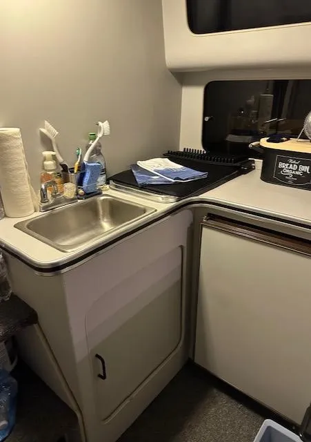 Slide: The Image of 1987 Chris-Craft 320 Amerosport kitchen area with sink, counter, and storage. - 16