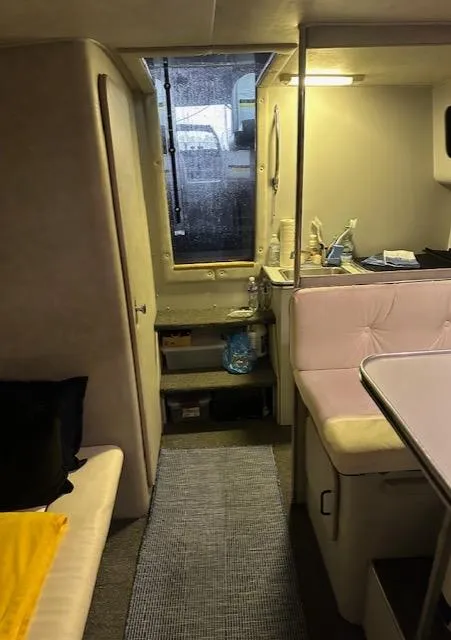 Slide: The Image of 1987 Chris-Craft 320 Amerosport cabin interior with seating and window view. - 17