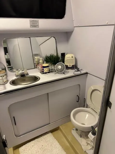 Slide: The Image of 1987 Chris-Craft 320 Amerosport bathroom with sink, toilet, and mirror. - 18