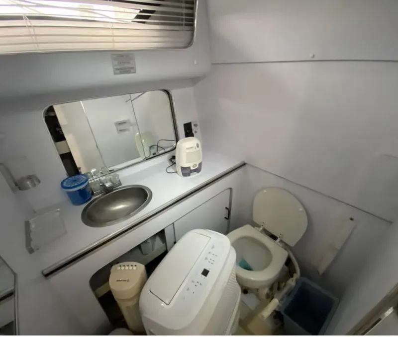Slide: The Image of 1987 Chris-Craft 320 Amerosport boat bathroom with sink, toilet, and compact appliances. - 19