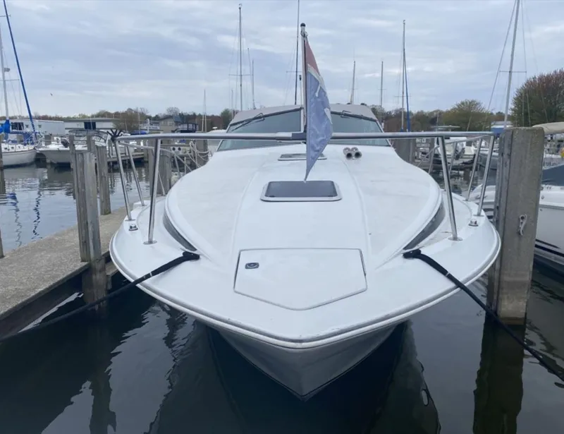 Slide: The Image of 1987 Chris-Craft 320 Amerosport docked at a marina, front view. - 2