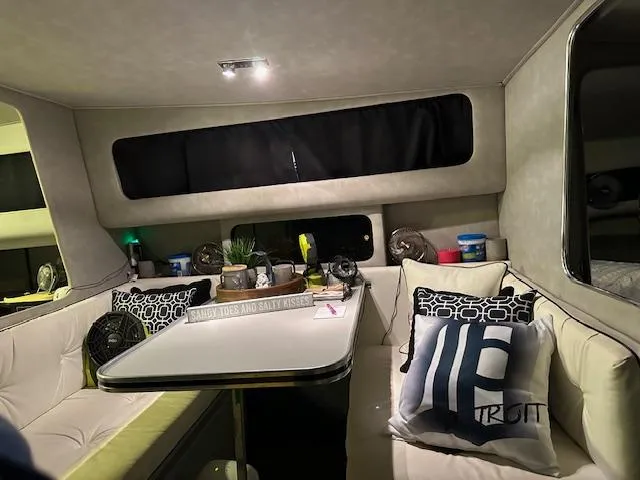 Slide: The Image of Interior of 1987 Chris-Craft 320 Amerosport boat with cozy seating and decorative pillows. - 20