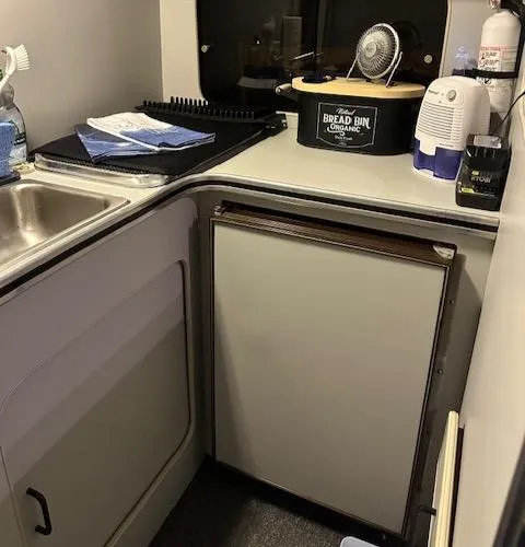 Slide: The Image of 1987 Chris-Craft 320 Amerosport kitchen area with sink, fridge, and countertop appliances. - 7