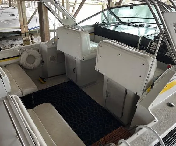 Slide: The Image of 1987 Chris-Craft 320 Amerosport boat interior with white seating and steering area. - 9