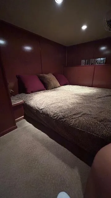 Slide: The Image of Cozy bedroom interior on 2007 Sharpe 18 x 85 houseboat with plush bedding and warm lighting. - 11
