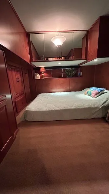 Slide: The Image of Cozy bedroom in 2007 Sharpe 18 x 85 houseboat with wood paneling and soft lighting. - 14