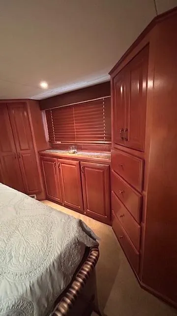 Slide: The Image of 2007 Sharpe 18 x 85 Houseboat bedroom with wooden cabinets and cozy decor. - 15