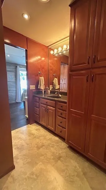 Slide: The Image of 2007 Sharpe 18 x 85 Houseboat bathroom with wooden cabinets and marble flooring. - 19