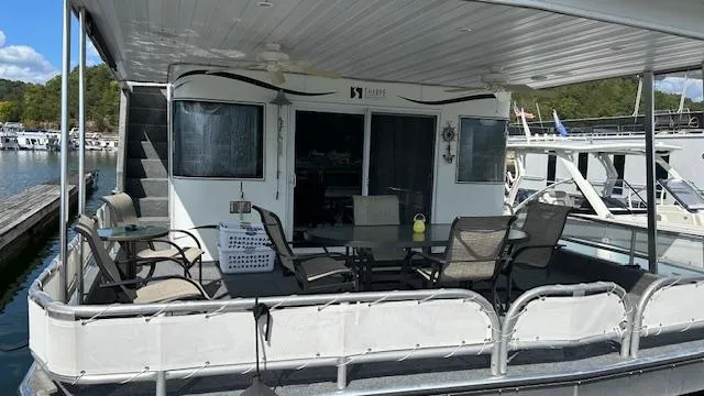 Slide: The Image of 2007 Sharpe 18 x 85 houseboat with outdoor seating on a sunny dock. - 2