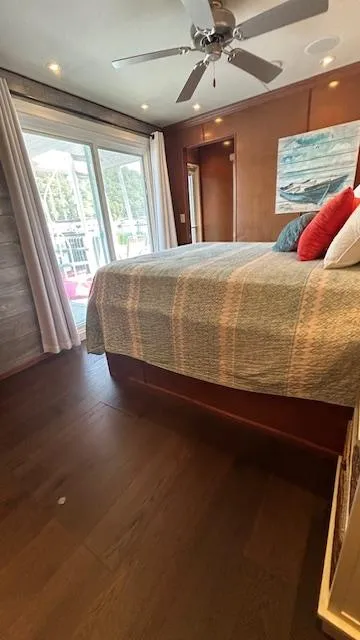 Slide: The Image of Bedroom interior of 2007 Sharpe 18 x 85 houseboat with bed, ceiling fan, and sliding glass door. - 21
