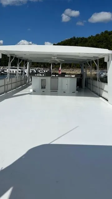 Slide: The Image of 2007 Sharpe 18 x 85 Houseboat with spacious deck under clear blue sky. - 23