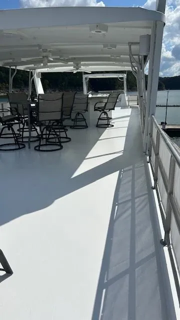Slide: The Image of 2007 Sharpe 18 x 85 Houseboat deck with chairs under a canopy, sunny day. - 3