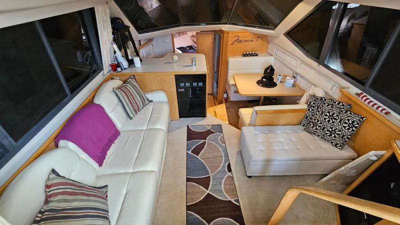Slide: The Image of Interior of 1995 Carver 355 Aft Cabin yacht with modern seating and decor. - 13