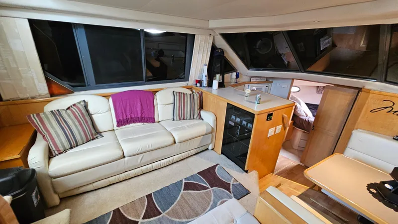Slide: The Image of Interior of 1995 Carver 355 Aft Cabin with sofa, kitchenette, and modern decor. - 14