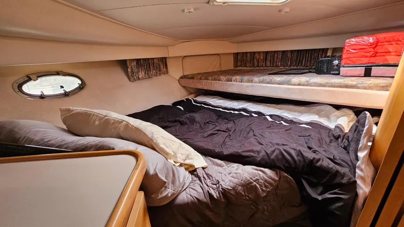 Slide: The Image of 1995 Carver 355 Aft Cabin interior with cozy bed and porthole window. - 19
