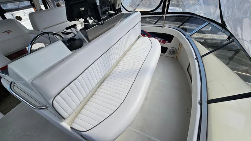 Slide: The Image of 1995 Carver 355 Aft Cabin interior with white seating and helm station. - 9