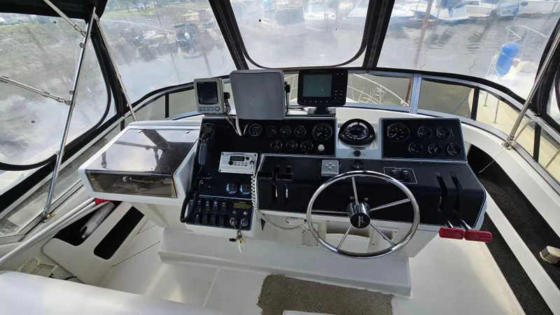 Slide: The Image of 1995 Carver 355 Aft Cabin helm with navigation instruments and steering wheel. - 10