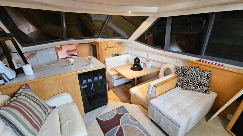 Slide: The Image of 1995 Carver 355 Aft Cabin interior with cozy seating, dining area, and modern decor. - 15