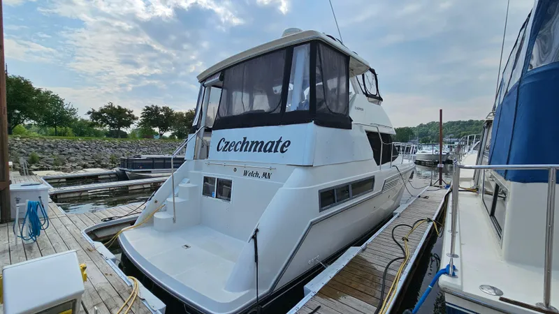 Slide: The Image of 1995 Carver 355 Aft Cabin yacht docked, featuring "Czechmate" name on the stern. - 3