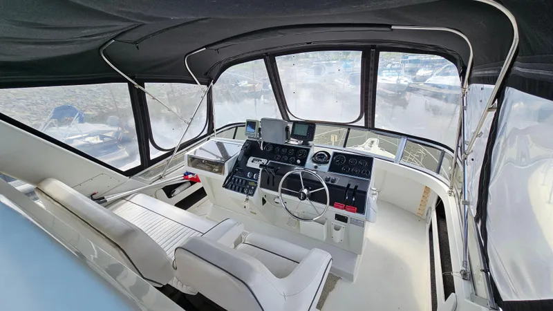Slide: The Image of 1995 Carver 355 Aft Cabin yacht helm with dual seats and navigation equipment. - 7