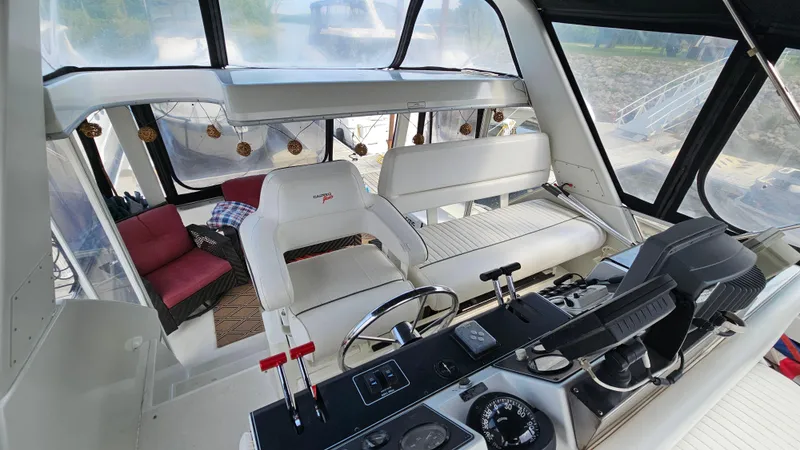 Slide: The Image of 1995 Carver 355 Aft Cabin interior with helm, seating, and controls. - 8