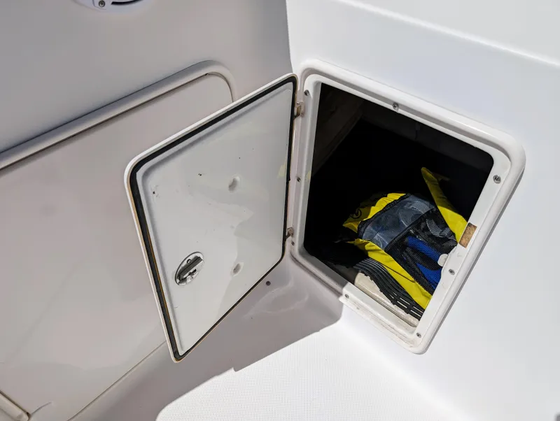 Slide: The Image of Open storage compartment on 2005 Regal 3560 boat with gear inside. - 13