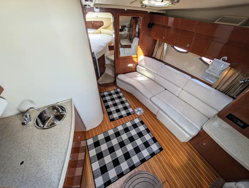 Slide: The Image of Luxurious interior of a 2005 Regal 3560 yacht with white leather seating and wood flooring. - 17
