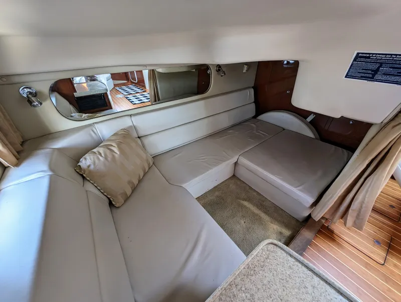 Slide: The Image of Interior of a 2005 Regal 3560 yacht with beige seating and wooden flooring. - 24